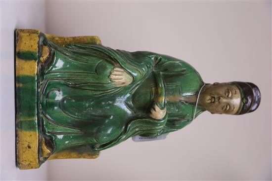 A Chinese sancai ridge tile modelled as the seated figure of Guandi, Ming dynasty, H. 30cm